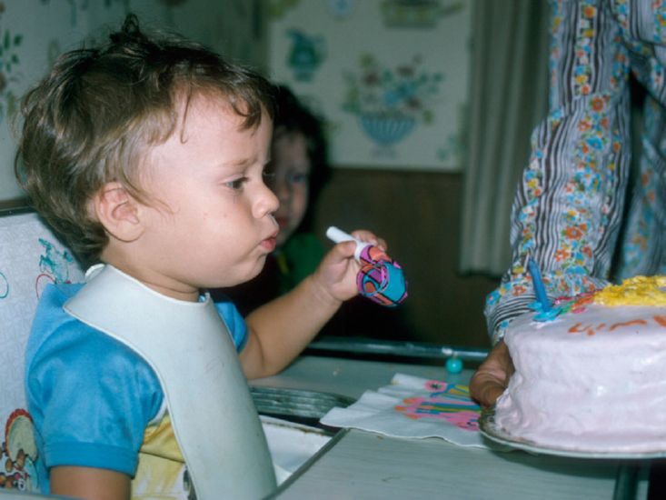  blowing out second birthday candles,  15 August 1975